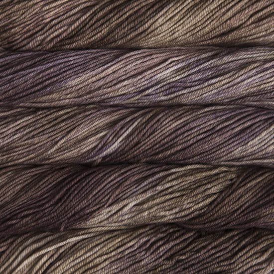 A close up of skeins of Malabrigo Rios worsted weight yarn in light and dark brown colors