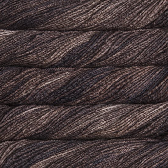 A close up of skeins of Malabrigo Rios worsted weight yarn in light and dark brown colors