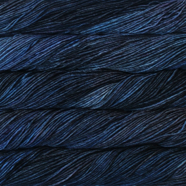 A close up of skeins of Malabrigo Rios worsted weight yarn in deep blue colors