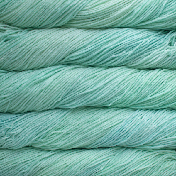 A close up of skeins of Malabrigo Rios worsted weight yarn in pale green color