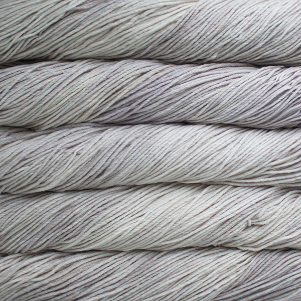 A close up of skeins of Malabrigo Rios worsted weight yarn in light grey color