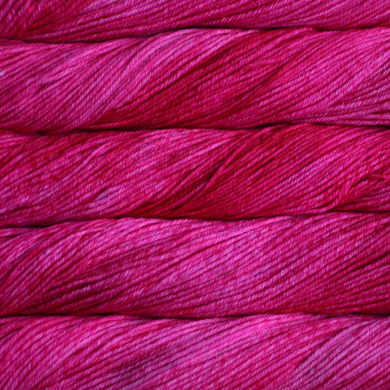 A close up of skeins of Malabrigo Rios worsted weight yarn in vibrant pink colors