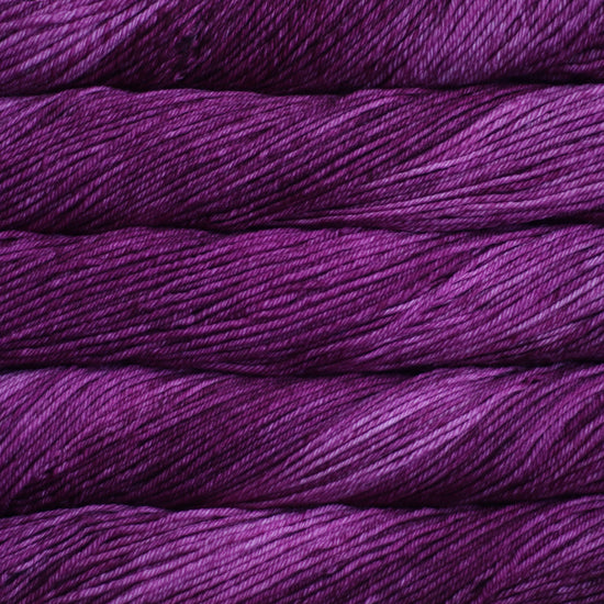 A close up of skeins of Malabrigo Rios worsted weight yarn in light and dark purple color