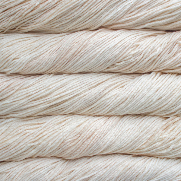 A close up of skeins of Malabrigo Rios worsted weight yarn in off white color