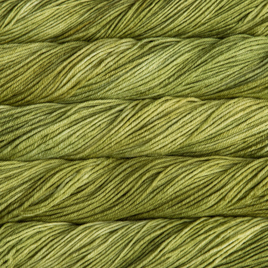 A close up of skeins of Malabrigo Rios worsted weight yarn in yellow green colors