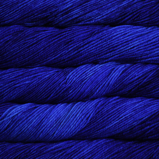 A close up of skeins of Malabrigo Rios worsted weight yarn in deep blue color