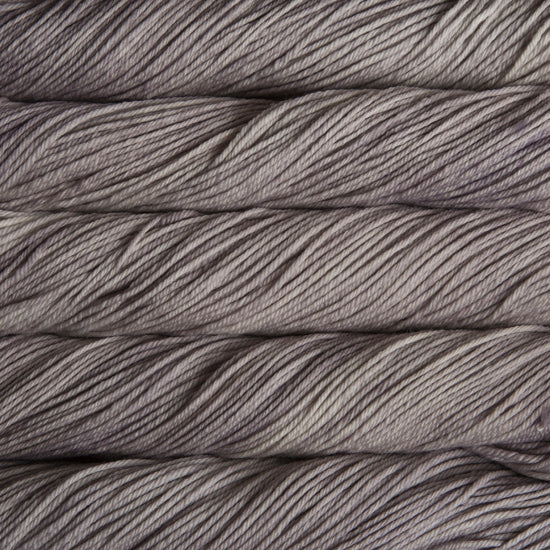 A close up of skeins of Malabrigo Rios worsted weight yarn in grey color