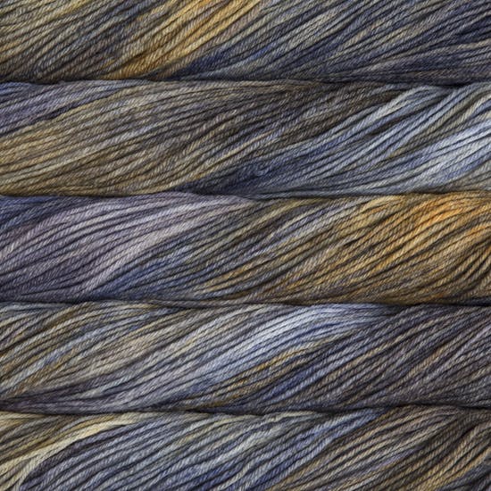 A close up of skeins of Malabrigo Rios worsted weight yarn in light and dark grey, blue, and yellow colors