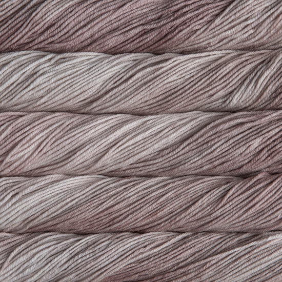 A close up of skeins of Malabrigo Rios worsted weight yarn in light grey color