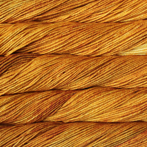 A close up of skeins of Malabrigo Rios worsted weight yarn in deep yellow color