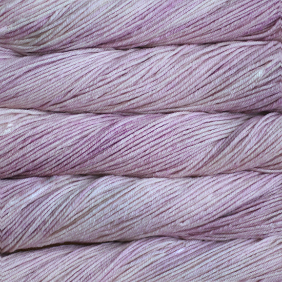 A close up of skeins of Malabrigo Rios worsted weight yarn in light pink color