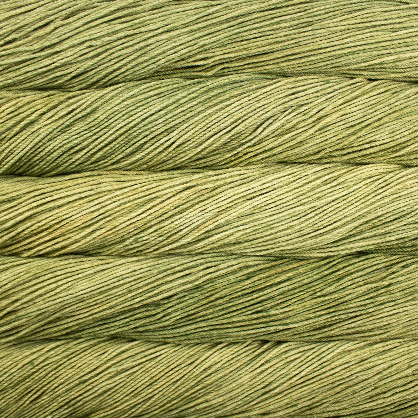 A close up of skeins of Malabrigo Rios worsted weight yarn in yellow green color