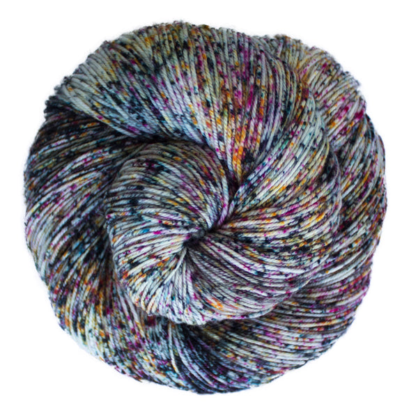 A close-up image of a skein of Malabrigo Sock yarn in an off-white base with speckling in a rainbow of colors.