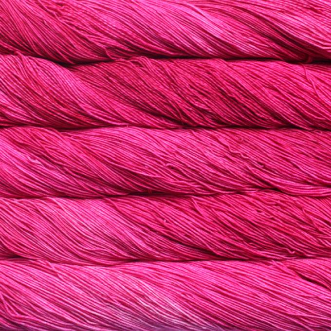 A close-up image of skeins of Malabrigo Sock yarn in bright pink.