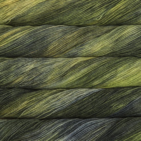 A close-up image of skeins of Malabrigo Sock yarn in forest green shades.