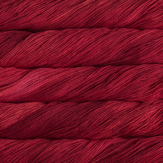 A close-up image of skeins of Malabrigo Sock yarn in bright red.