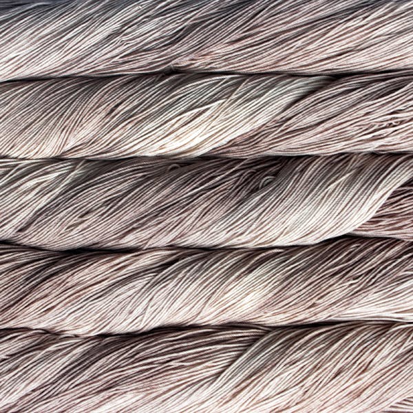 A close-up image of skeins of Malabrigo Sock yarn in taupe.