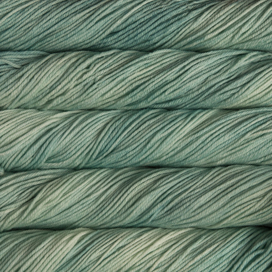 A close up of skeins of Malabrigo Rios worsted weight yarn in pale green color