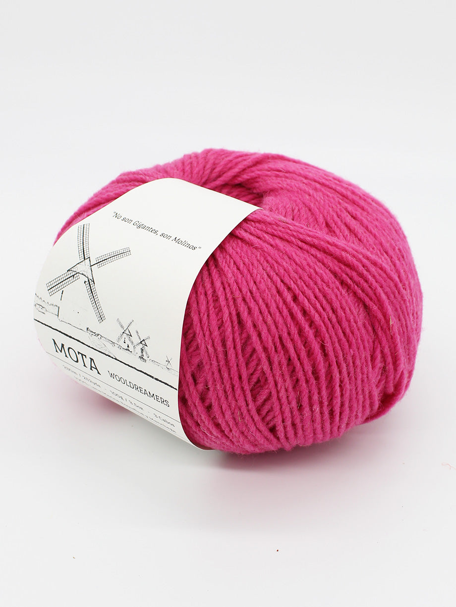 A skein of fuscia yarn on a white background.