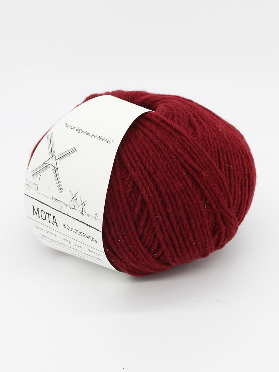 A skein of scarlet red yarn on a white background.