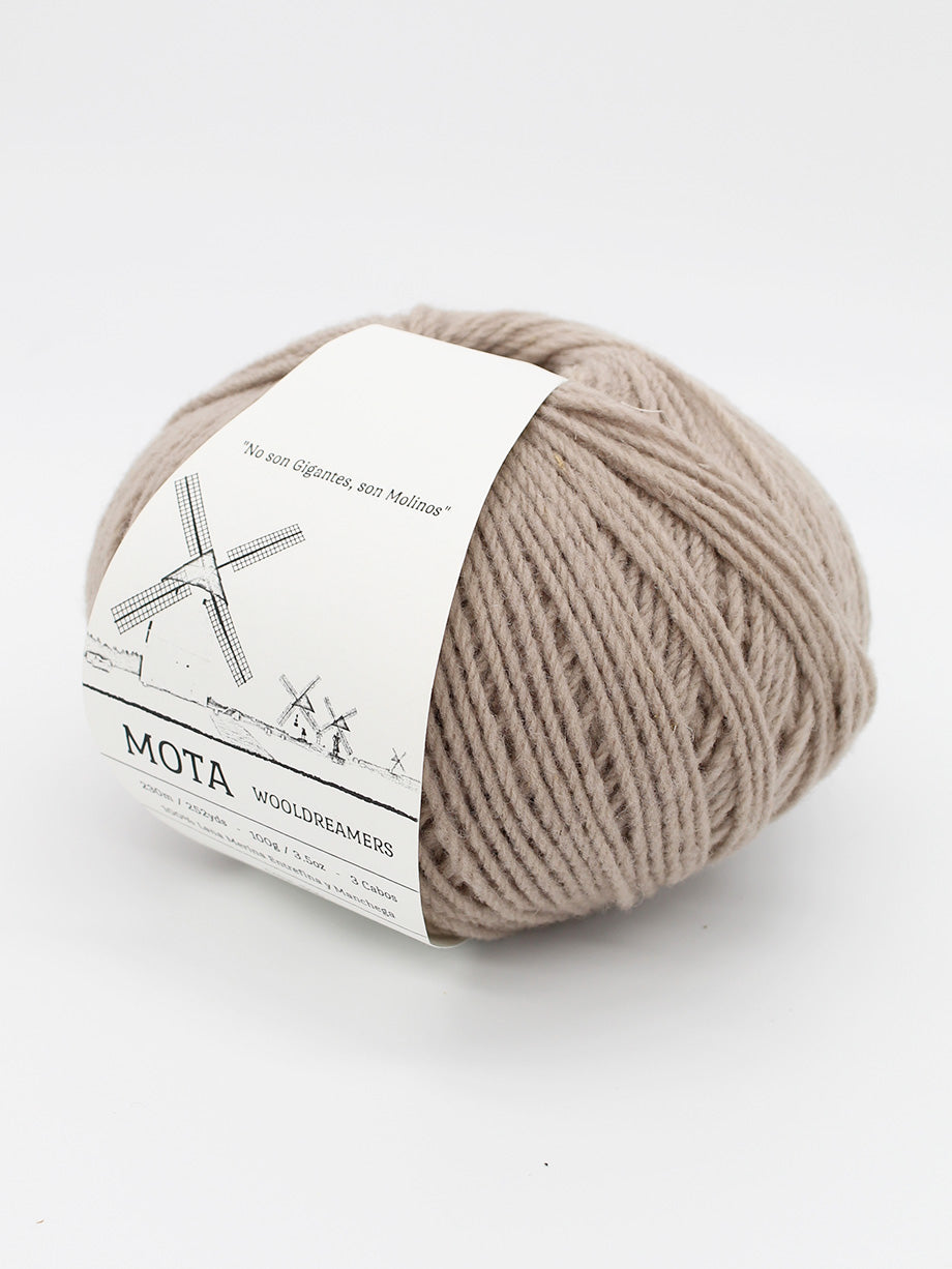 A skein of tan yarn on a white background. 