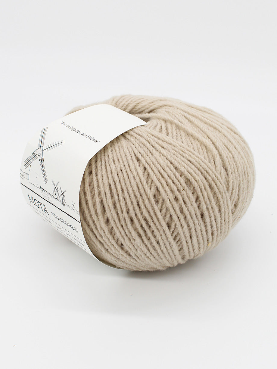 A skein of light tan yarn on a white background.